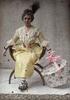 Woman in yellow victorian day dress with hat box