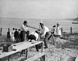 Beach event -- Men building fire pit