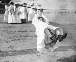 Beach event -- Girl swinging on rope