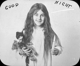 Little girl with doll and candle captioned "Good Night"