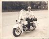 Officer Armitage on motorcycle delivered April 15, 1975